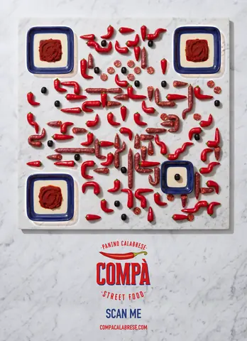 Compà poster: chili peppers and salami on marble with blue antipasto plates as the finder squares