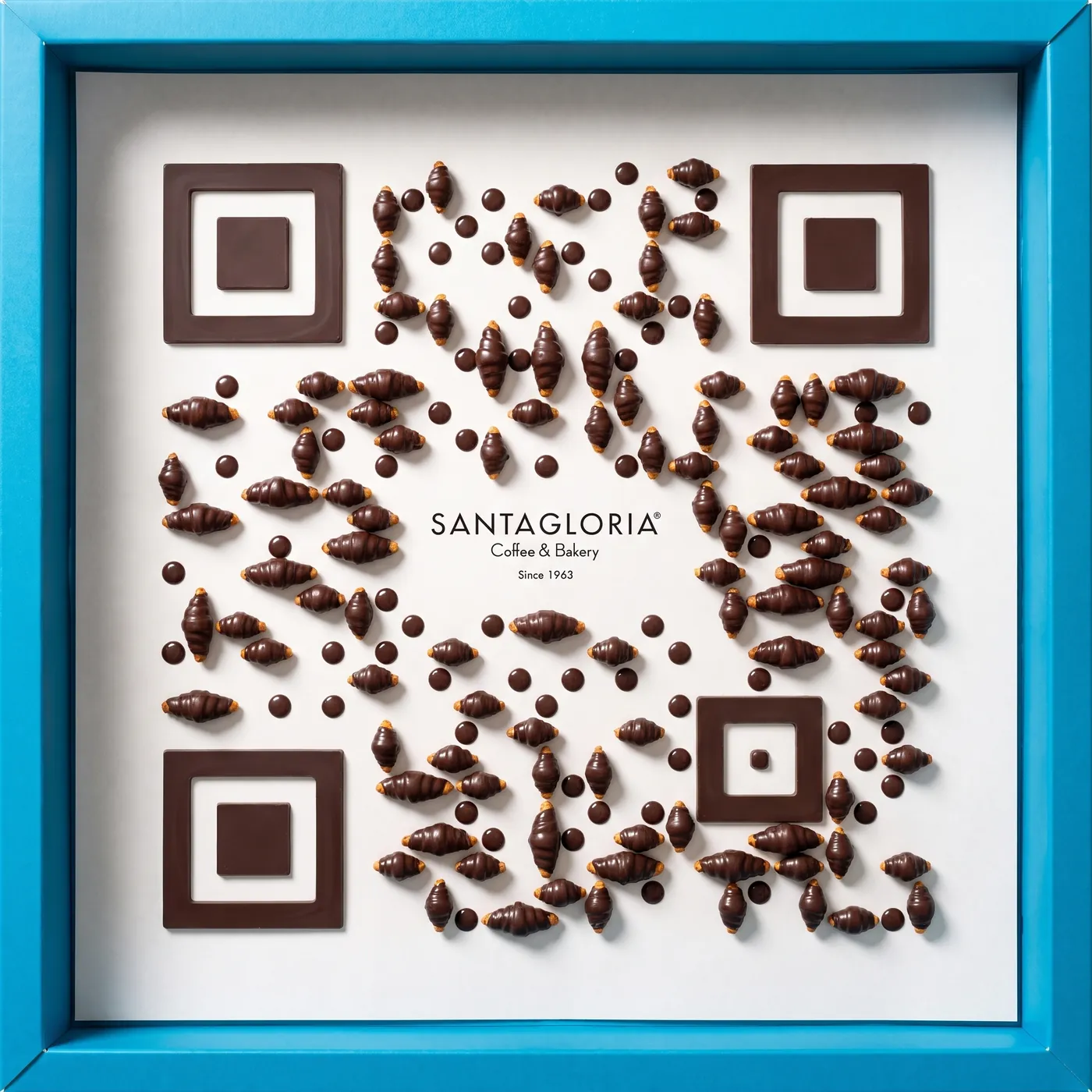 Santagloria code: chocolate glorias arranged as a QR code in the sky-blue box