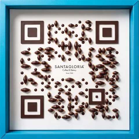 Santagloria code: chocolate glorias arranged as a QR code in the sky-blue box