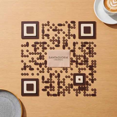 Santagloria code made of gloria pastries on a wooden table